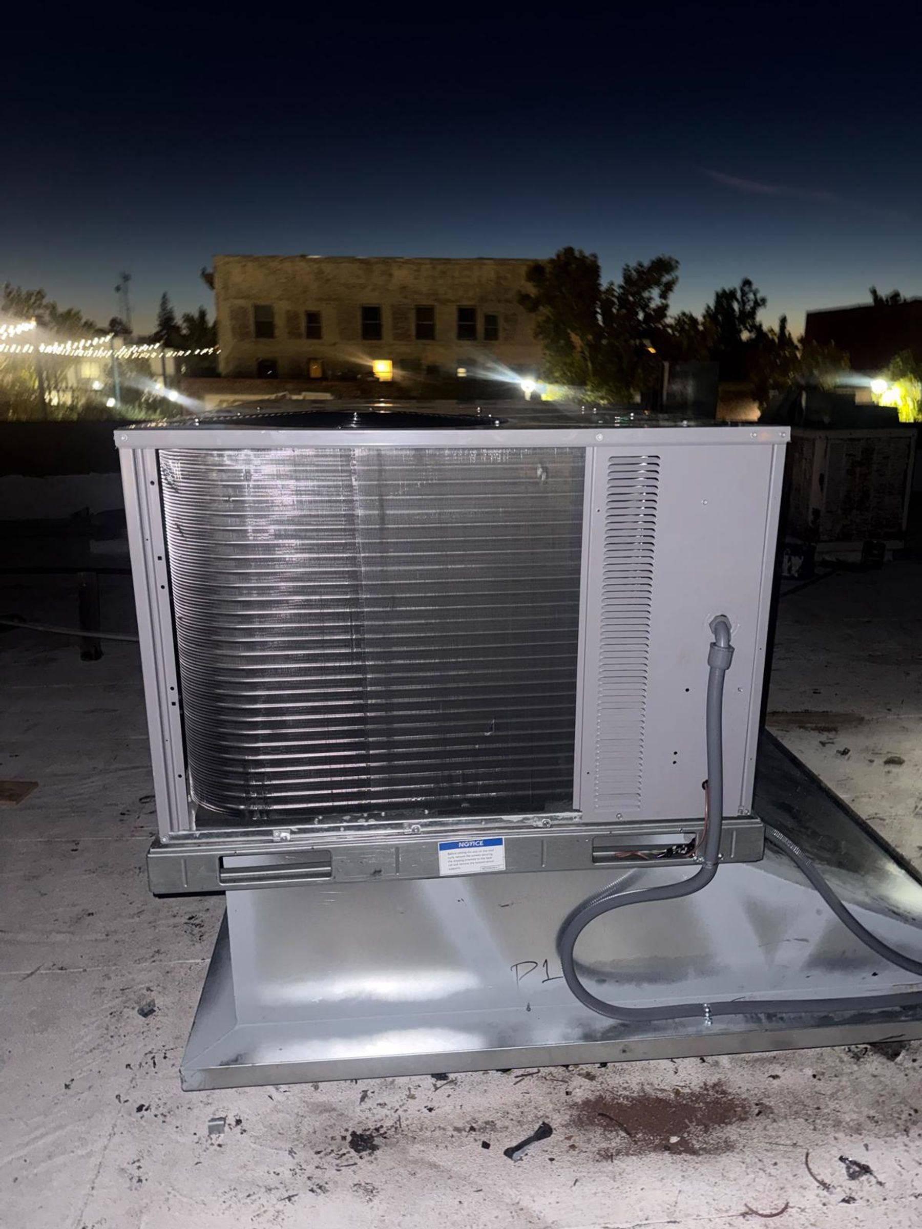 A commercial packaged rooftop air conditioning unit on a curb.