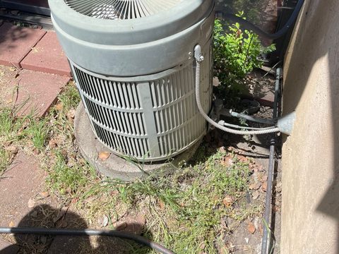 a newly installed residential condenser unit beside a house in the Stockton area