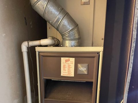 a residential furnace installed in a utility closet