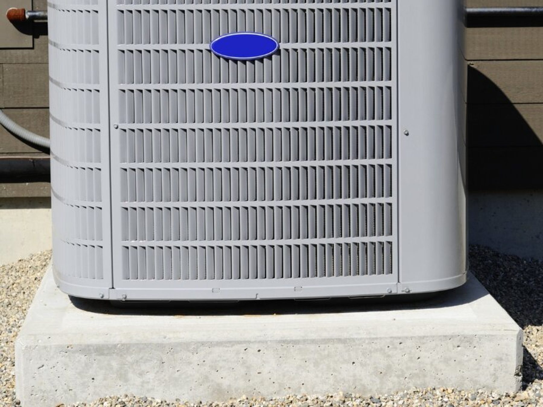 A newly installed condenser unit on a concrete pad.