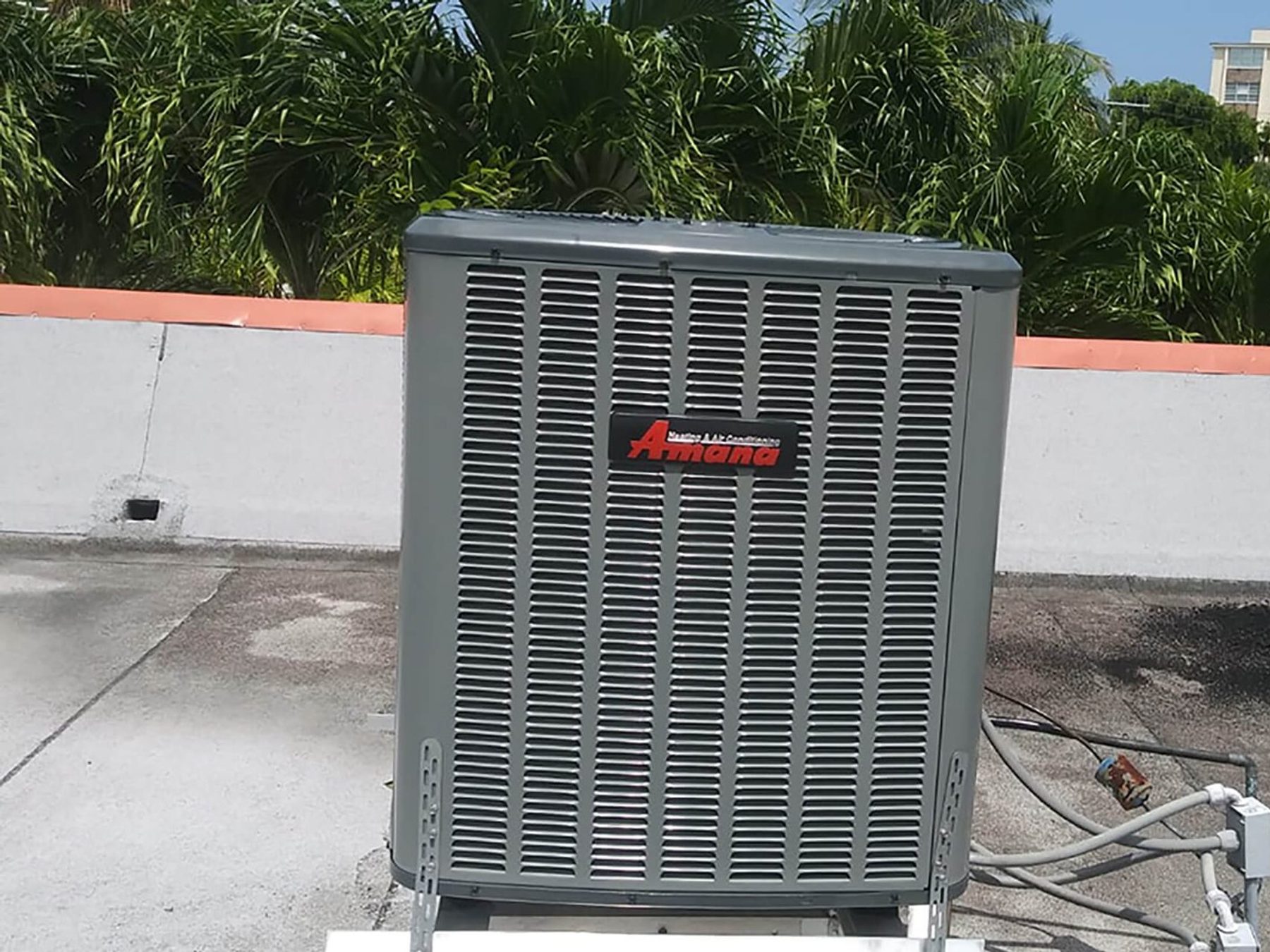 A technician working on an air conditioning electrical disconnect.