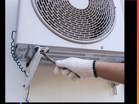 a technician servicing a condenser fan motor