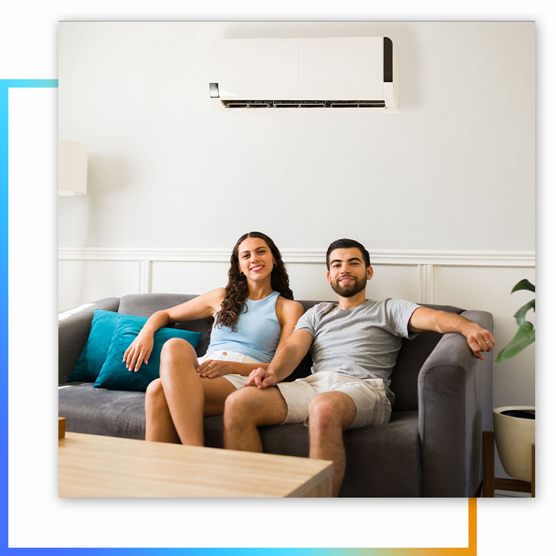 couple comfortable on couch with AC above